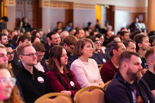 A person watching the keynote from the back of the hall