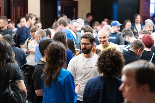 A man looking at his phone on the stairs