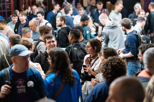 Photo of the crowd, centered on a man with a ponytail