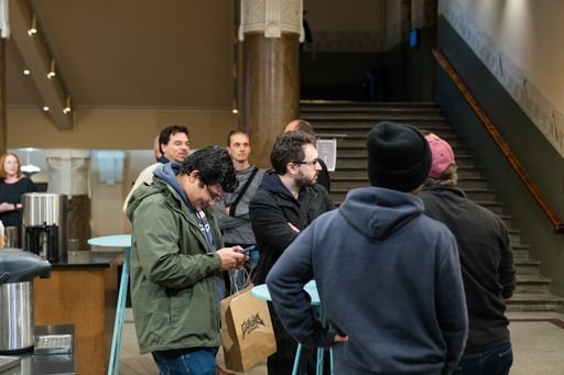 Some attendees in the foyer