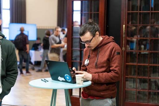 A man on his laptop in the foyer