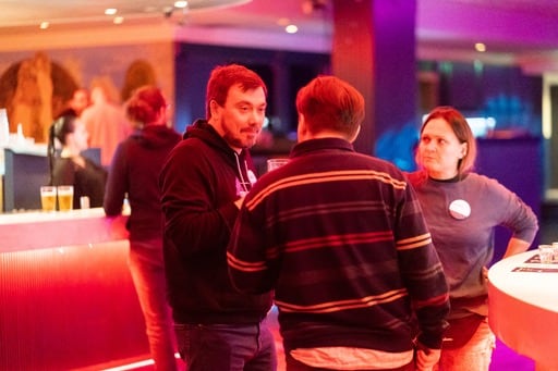 A group of three poeple at the party