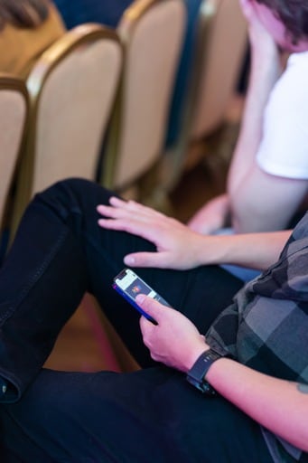 Audience memeber on their phone