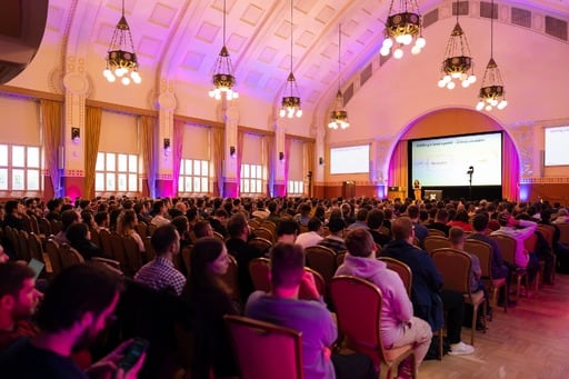 Yarden Laifenfeld presenting. Audience in foreground.